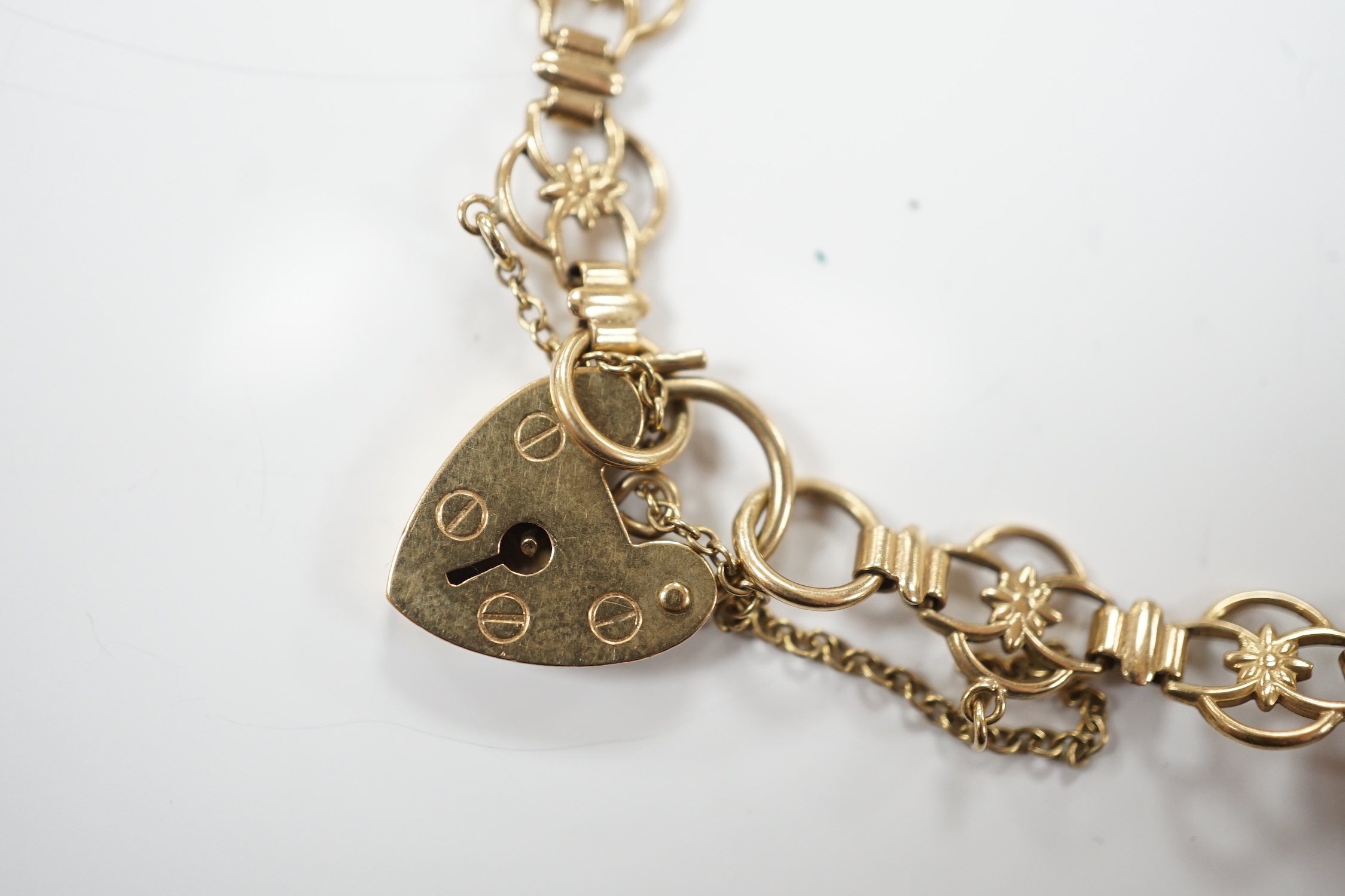 A modern 9ct gold charm bracelet hung with four shell charms, gross weight 19.1 grams.